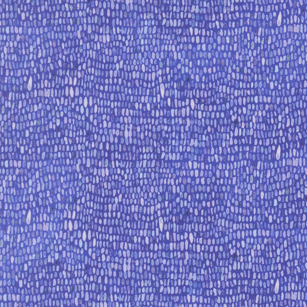 Close-up of a textured purple fabric with small, irregularly shaped lighter purple and white dashes.