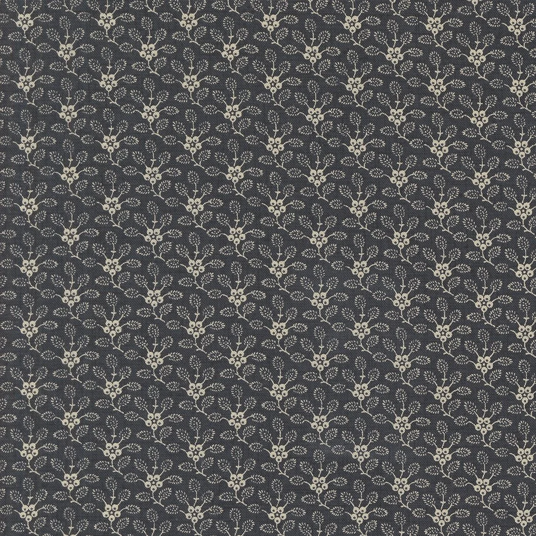 A patterned fabric with small light-colored floral and leaf motifs on a dark background.
