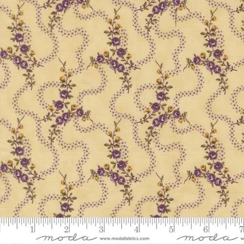 Yellow fabric with purple floral pattern and dotted wavy lines, with a ruler at the bottom showing measurements.