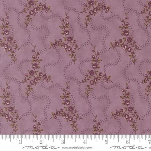 Lavender fabric with a floral vine pattern and dotted lines.