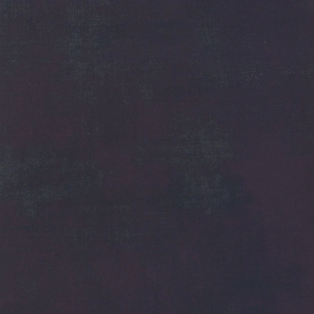 Dark, textured surface with subtle variation in shading.