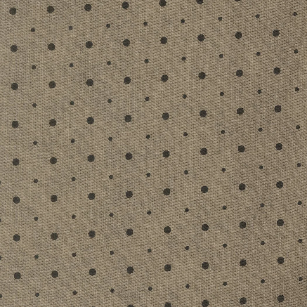 Beige fabric with black polka dots.