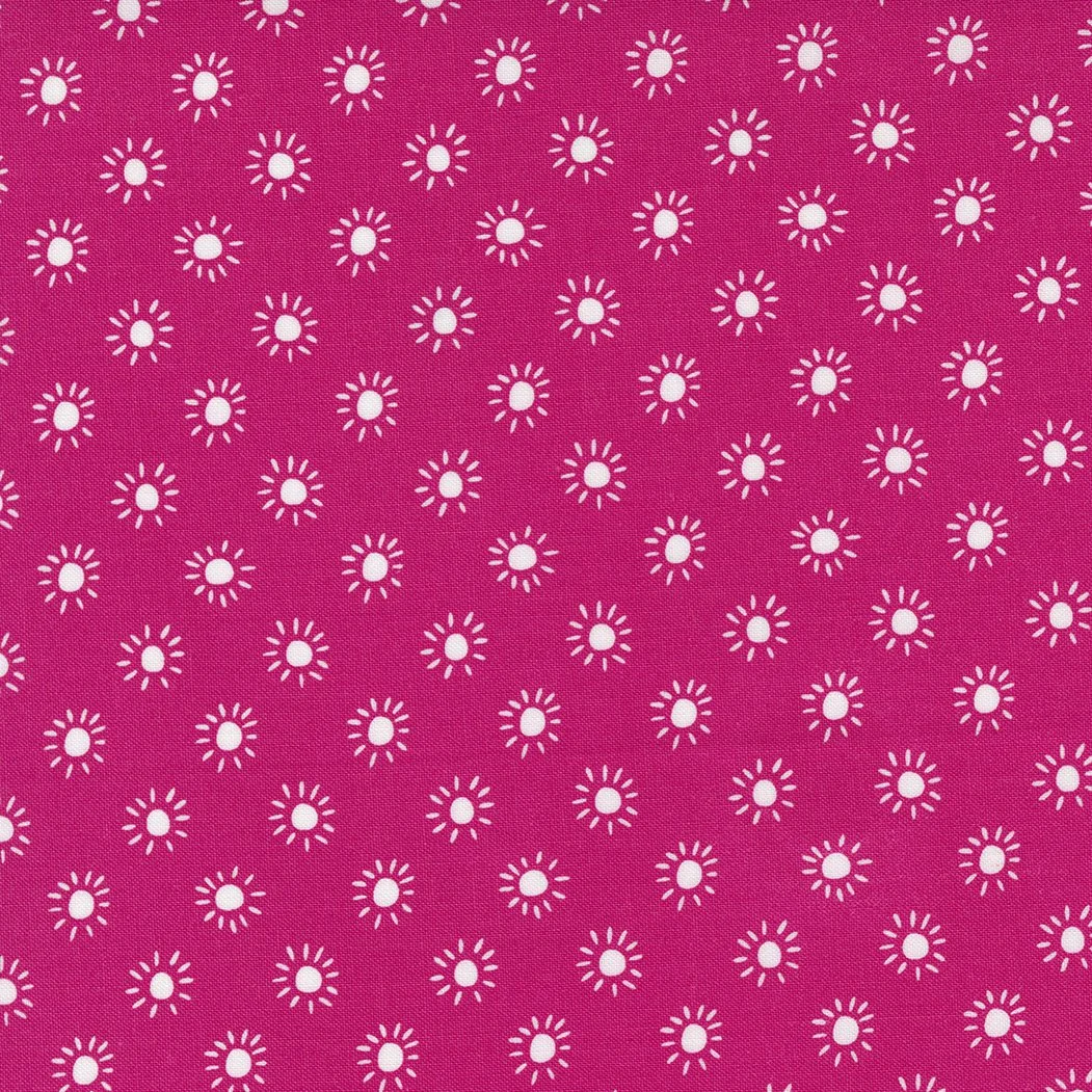 Pink fabric with white sunburst circular patterns.