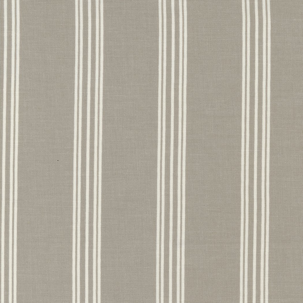 Close-up of beige fabric with vertical white and light gray striped pattern.