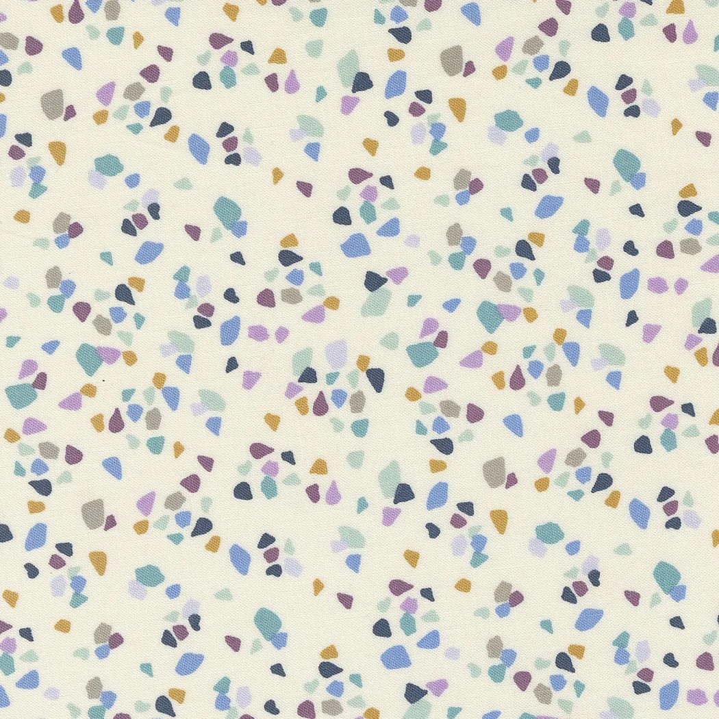 Colorful confetti pattern on a light background with irregular shapes in shades of blue, purple, gray, teal, and orange.