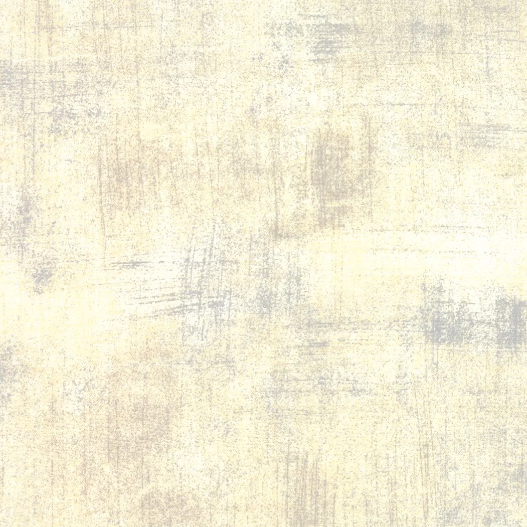 Plain textured beige wall with subtle gray and yellowish streaks.
