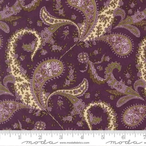 Close-up of purple fabric with a floral paisley pattern in lavender, cream, and green hues.