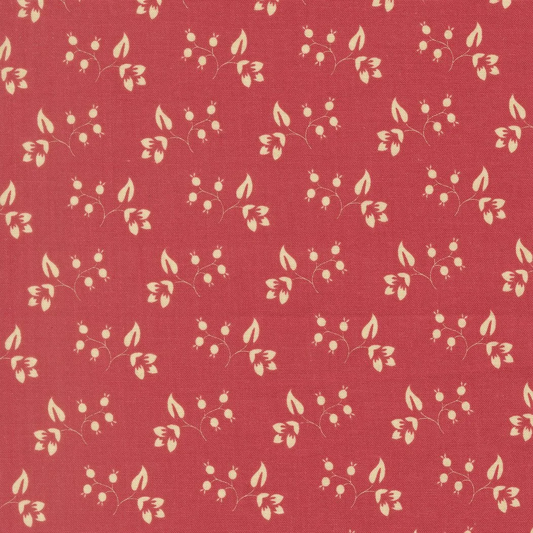 Red fabric with a repeating pattern of white floral and berry motifs.