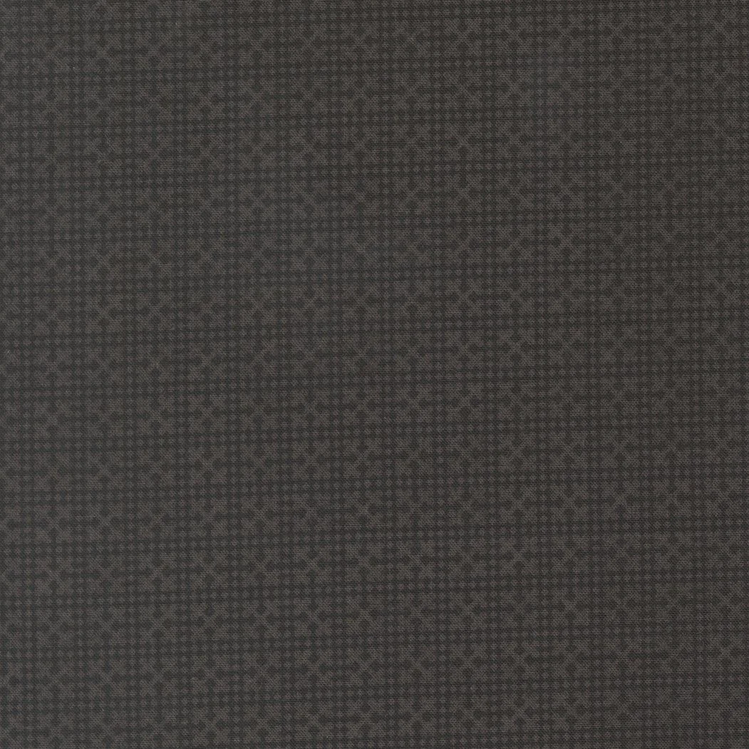 Close-up of a dark textured fabric surface.