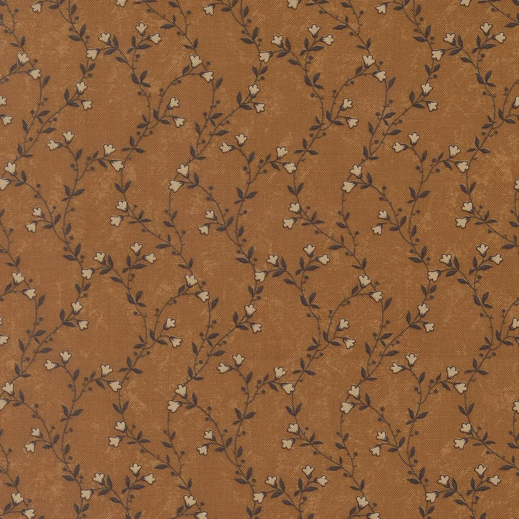 A fabric with a brown background and a pattern of small beige and black flower and leaf motifs arranged in diagonal rows.