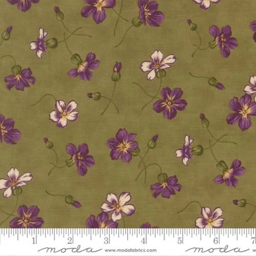 Green fabric with purple and white floral pattern, including small purple flowers and green vine accents.