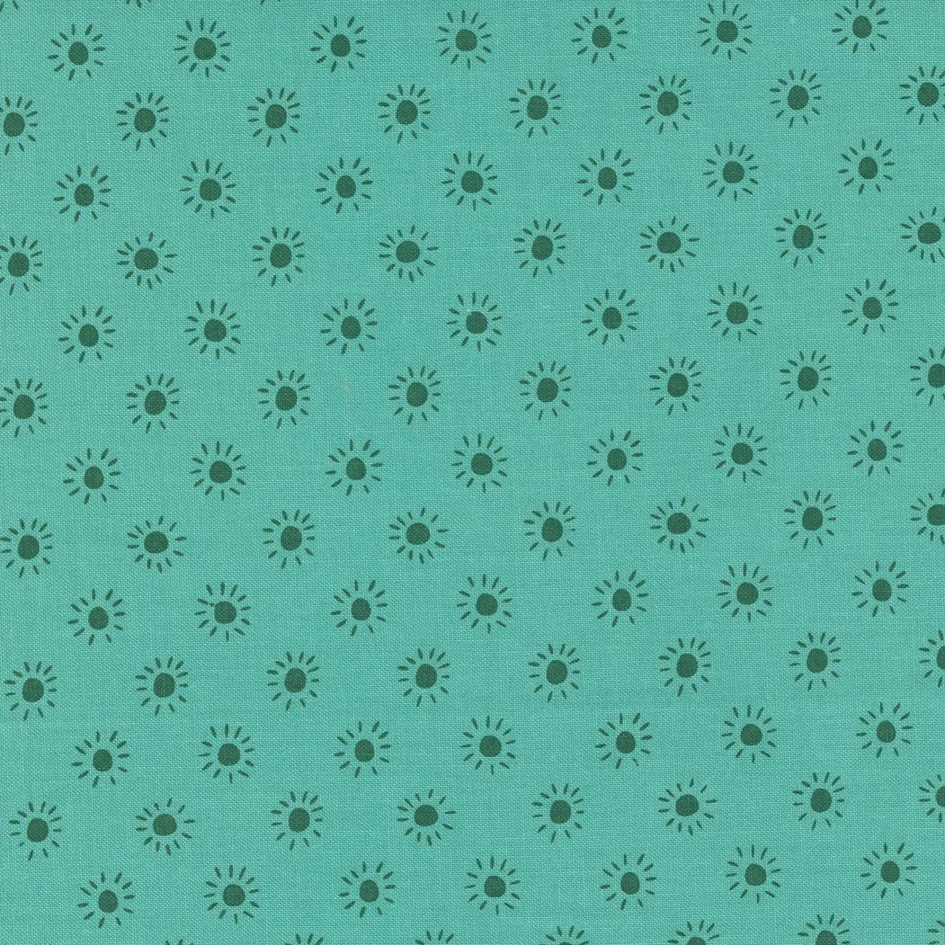 Turquoise fabric with small, dark teal sunburst pattern evenly spaced across the surface.