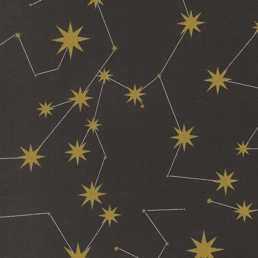 A dark fabric with a pattern of yellow stars and constellation lines, resembling a night sky.