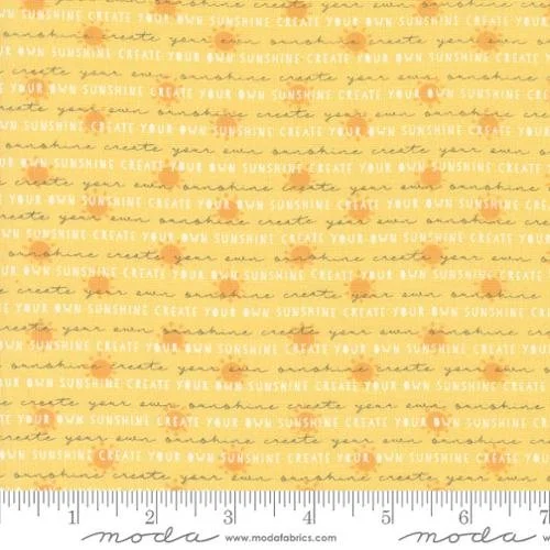 Close-up of fabric with a repeated pattern of yellow and orange horizontal stripes and the phrase 'Create Your Own Sunshine' in cursive across it.