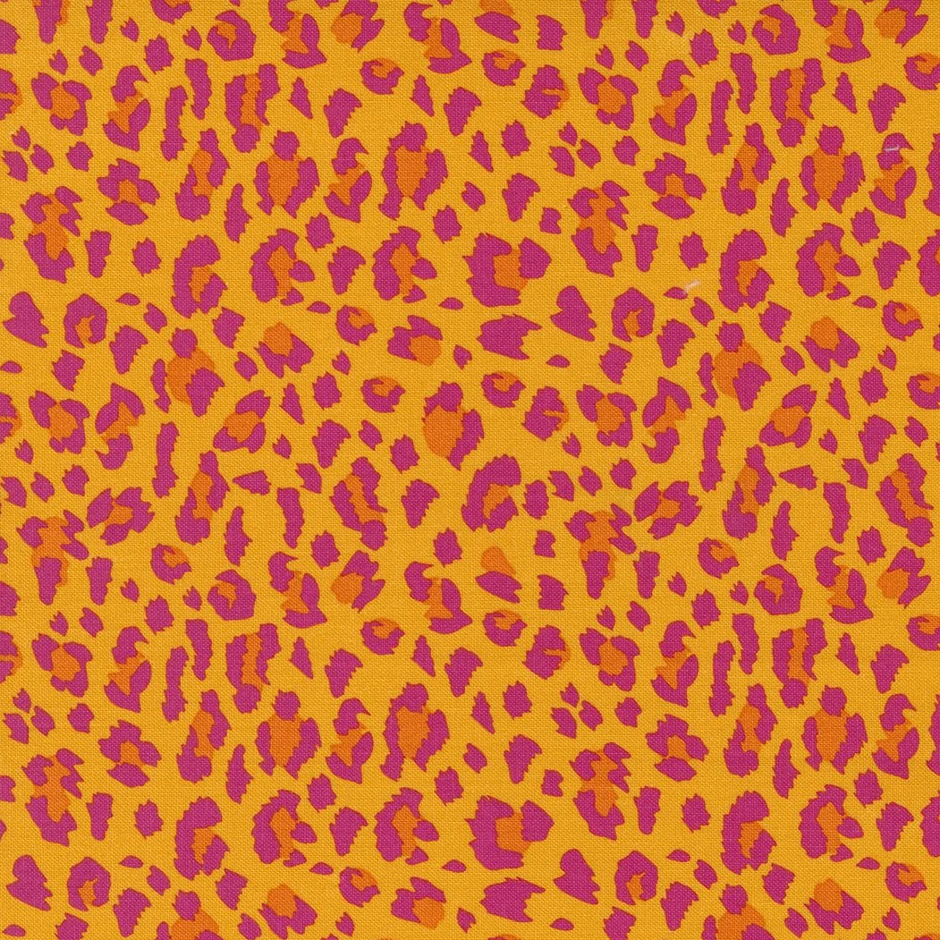Bright yellow fabric with pink and orange leopard print pattern.