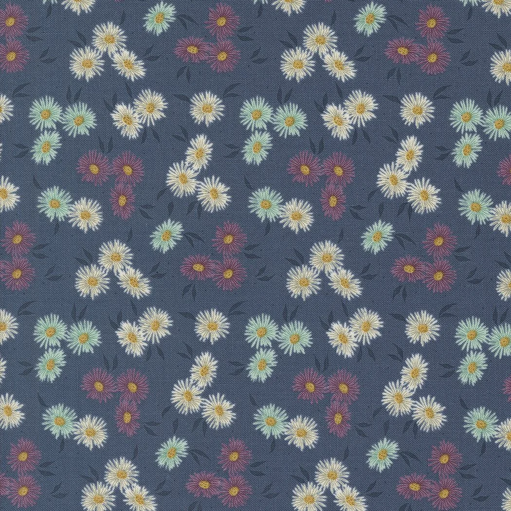 Fabric with a dark blue background and a floral pattern of white daisies with yellow centers and pink and light green flowers with yellow centers.