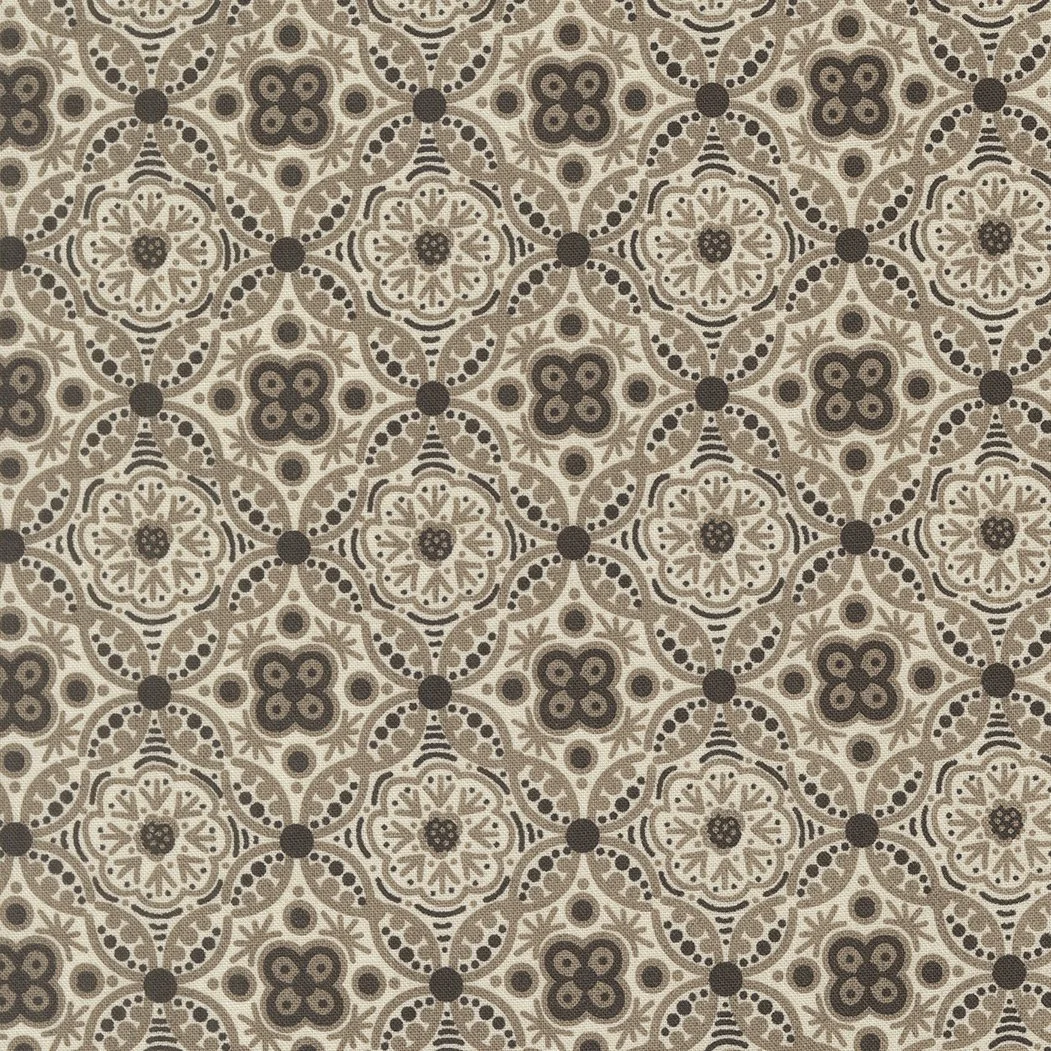 Patterned surface with symmetrical geometric and floral designs in beige, brown, and black colors.