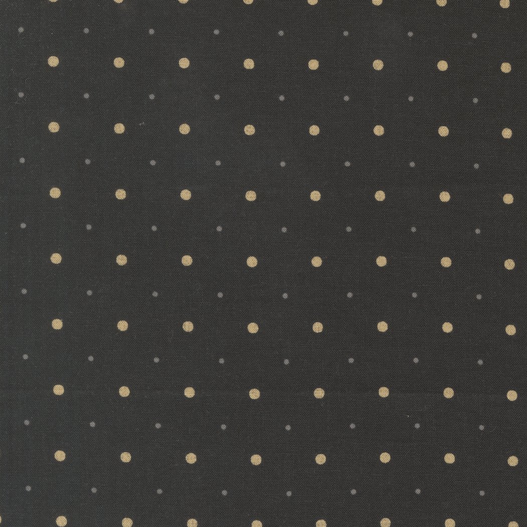 Close-up of black fabric with a pattern of evenly spaced small white and gray polka dots.