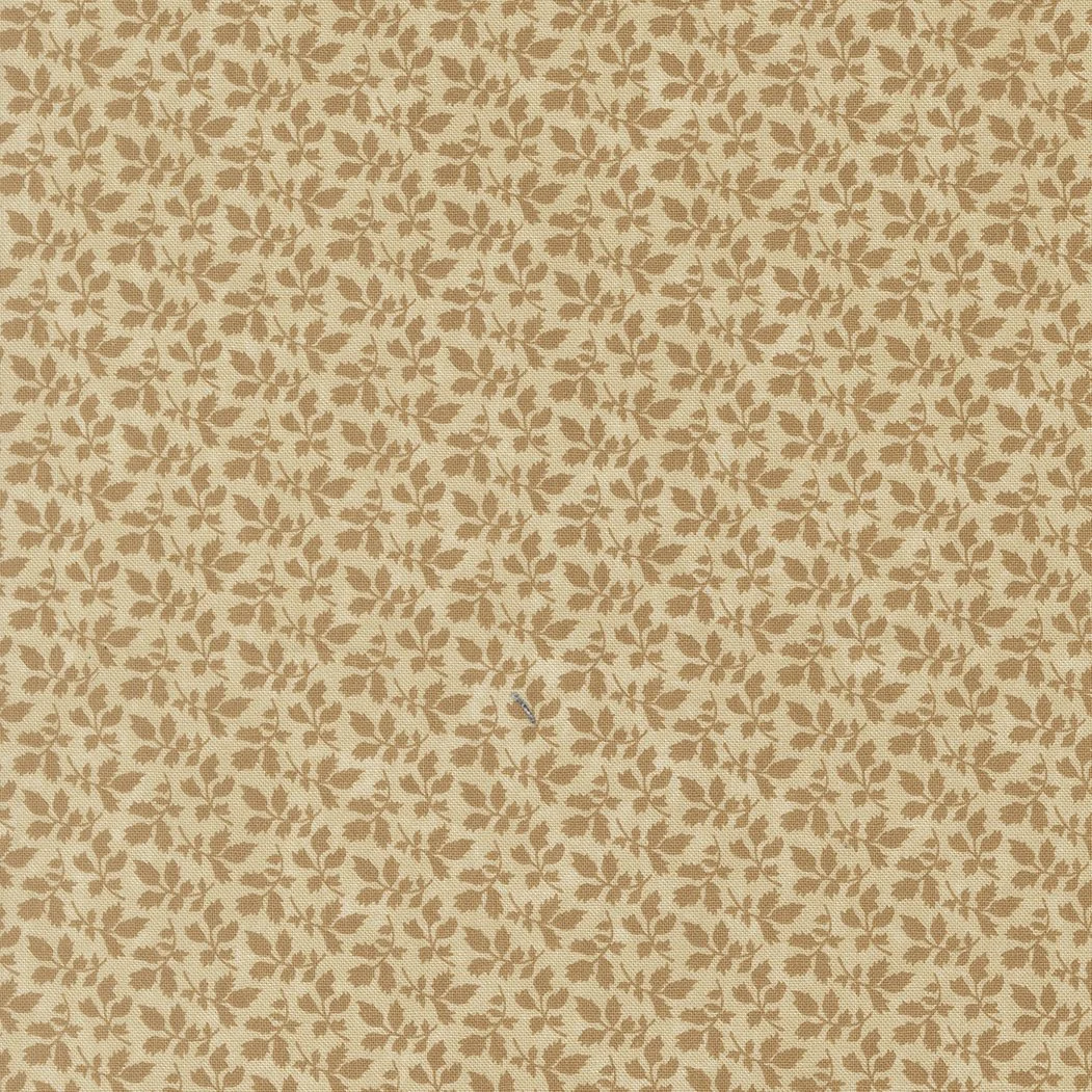 Beige fabric with a small, repeating leaf pattern in darker beige or light brown.