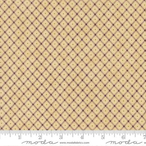 Close-up of fabric with yellow background and a purple diamond pattern, featuring small purple dots at intersections, along a measuring ruler at the bottom.
