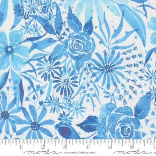 Blue and white floral patterned fabric with roses, daisies, and various leaves, featuring a ruler at the bottom measuring approximately 7 inches.