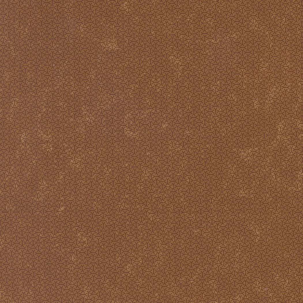 Close-up view of a textured fabric with a detailed brown and tan pattern.