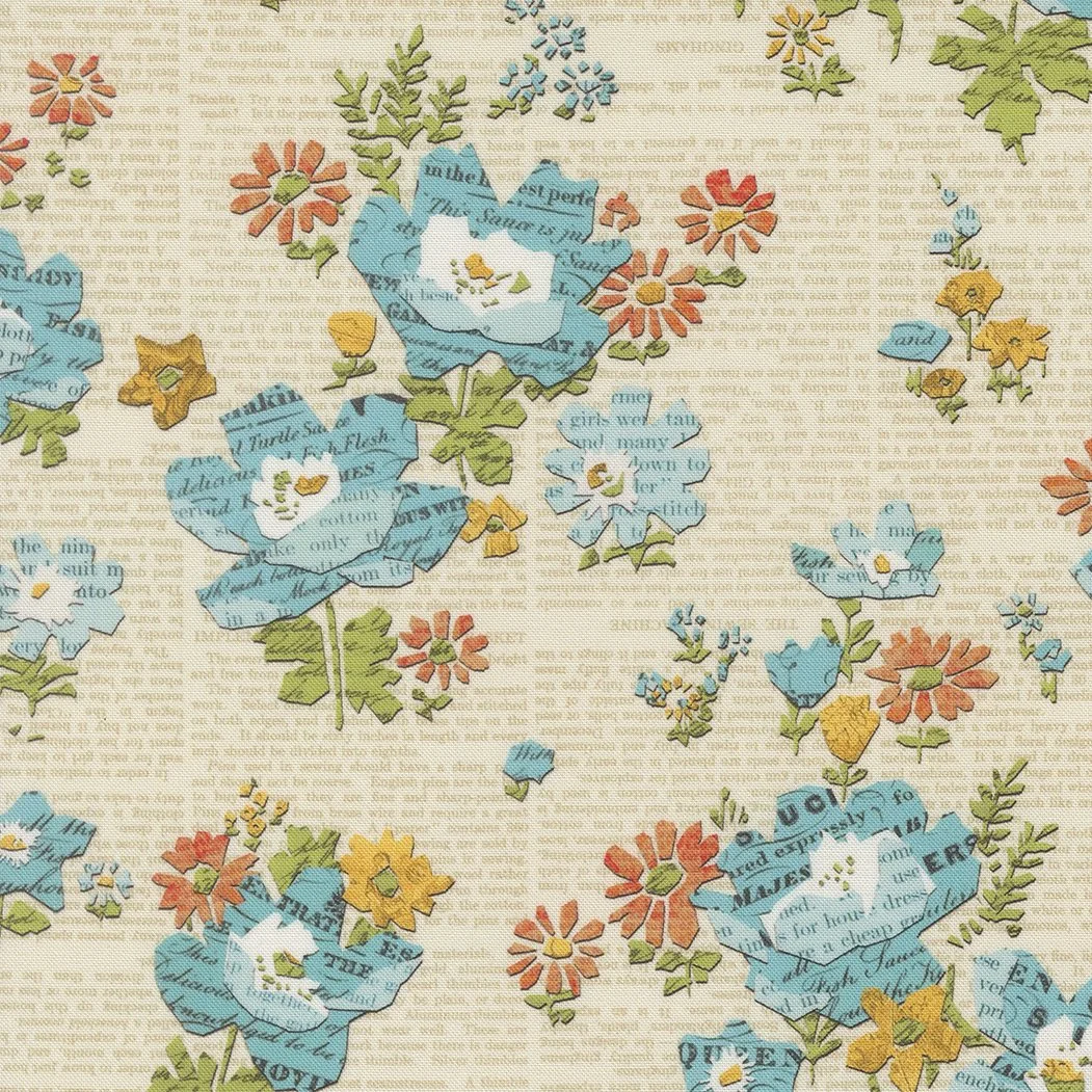 Fabric with a colorful floral pattern featuring blue, orange, yellow, and green flowers and leaves, with some flowers made of paper text.