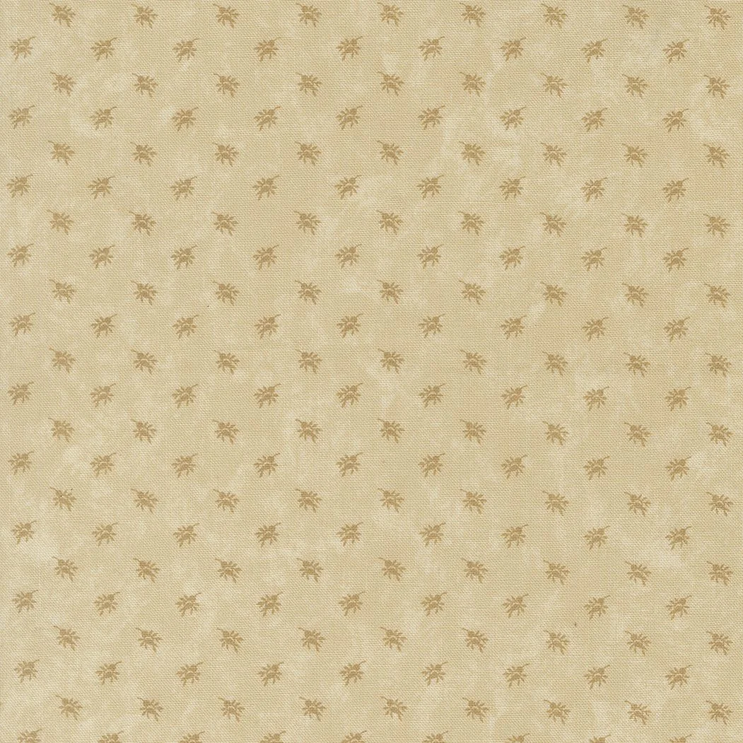 Gold-colored fabric with a subtle pattern of small, evenly spaced leaves.
