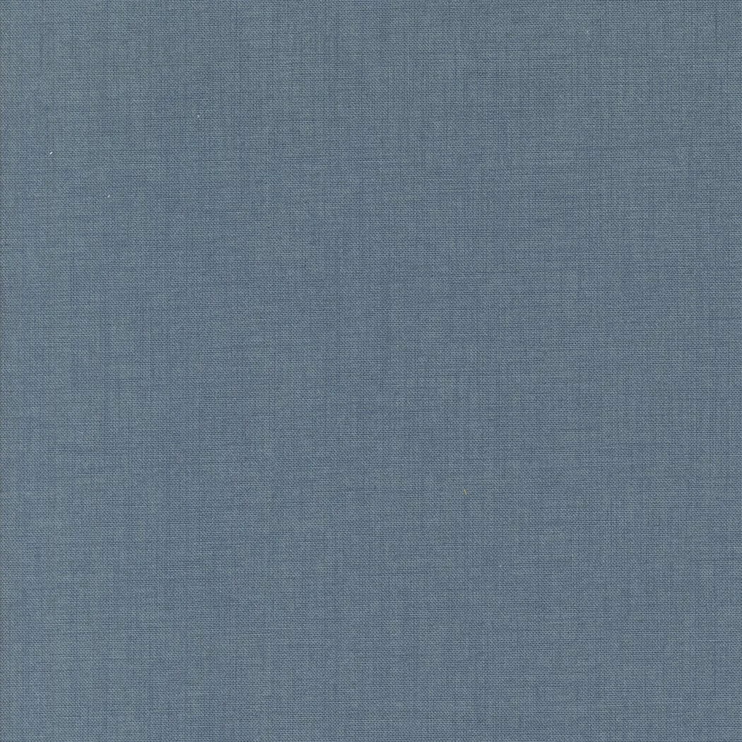 Close-up of a blue fabric with a textured weave pattern.