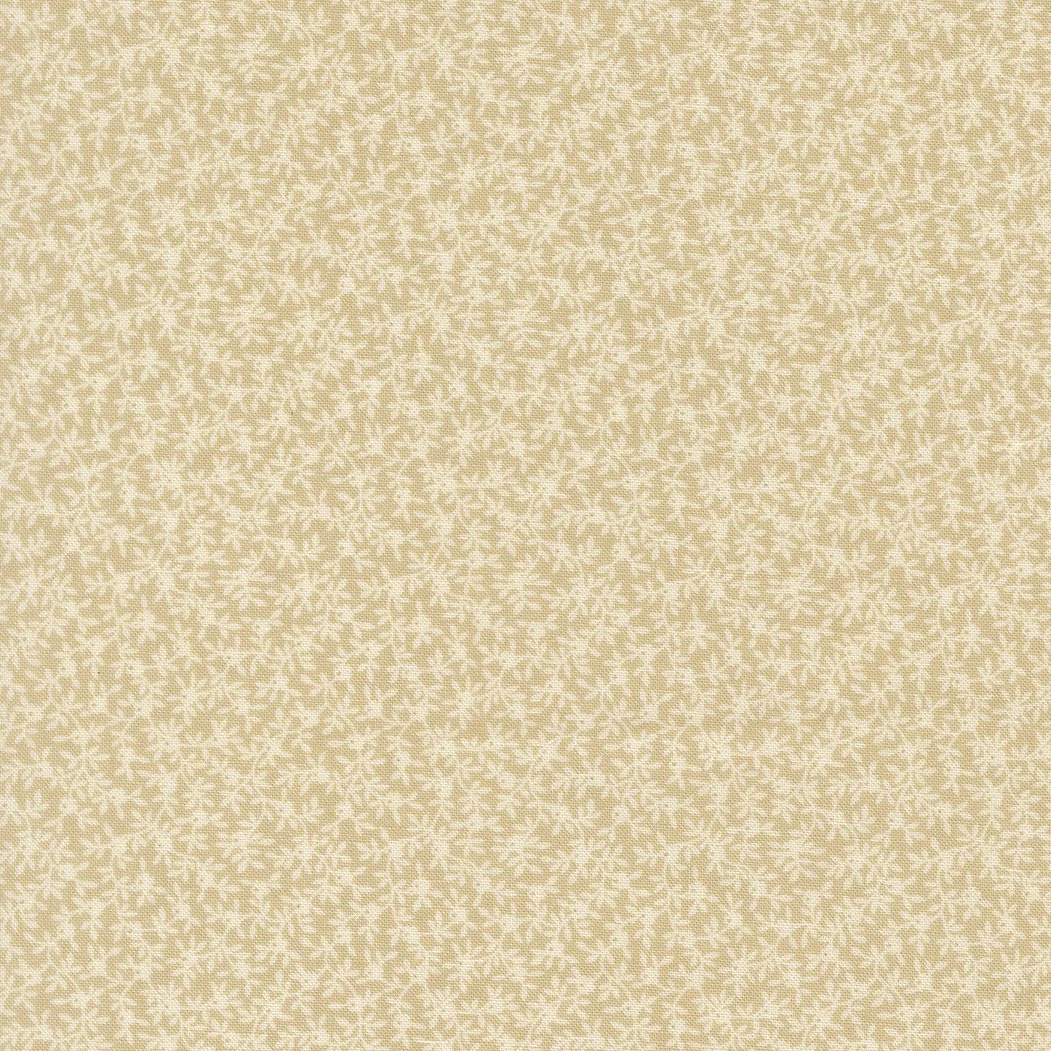 Close-up view of beige fabric with a textured, speckled pattern.