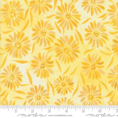 Yellow floral fabric with orange flowers and leaves, with a measuring ruler at the bottom.