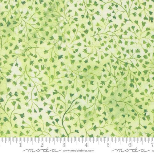 Light green fabric with a pattern of small, dark green leafy vines and branches.