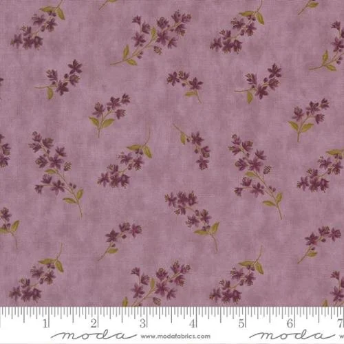 Lavender fabric with small purple flowers and green leaves, printed on a pink background.