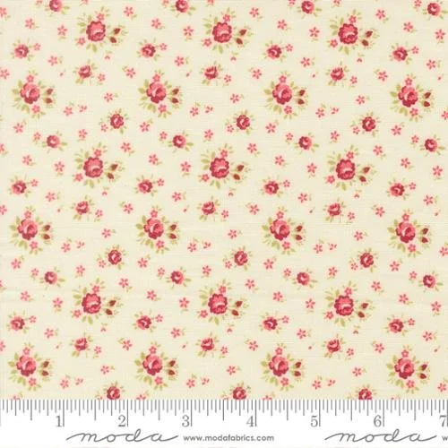 Cream fabric with pink floral pattern and a ruler at the bottom.