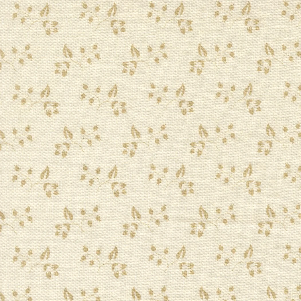 Close-up of beige fabric with a subtle floral pattern of small leaves and berries.