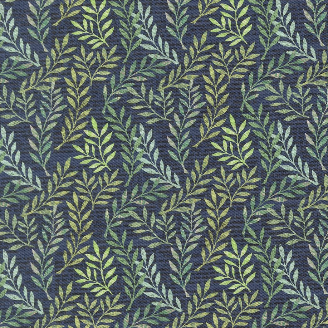 Close-up of fabric with a pattern of green leafy branches on a dark blue background.