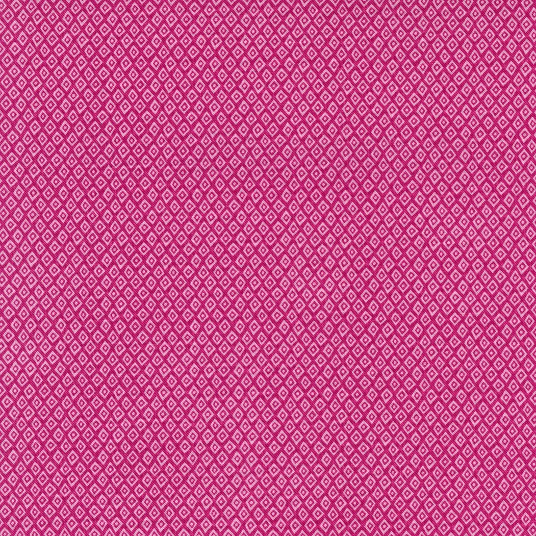 Close-up of a pink fabric pattern with white diamond shapes forming a repetitive geometric design.