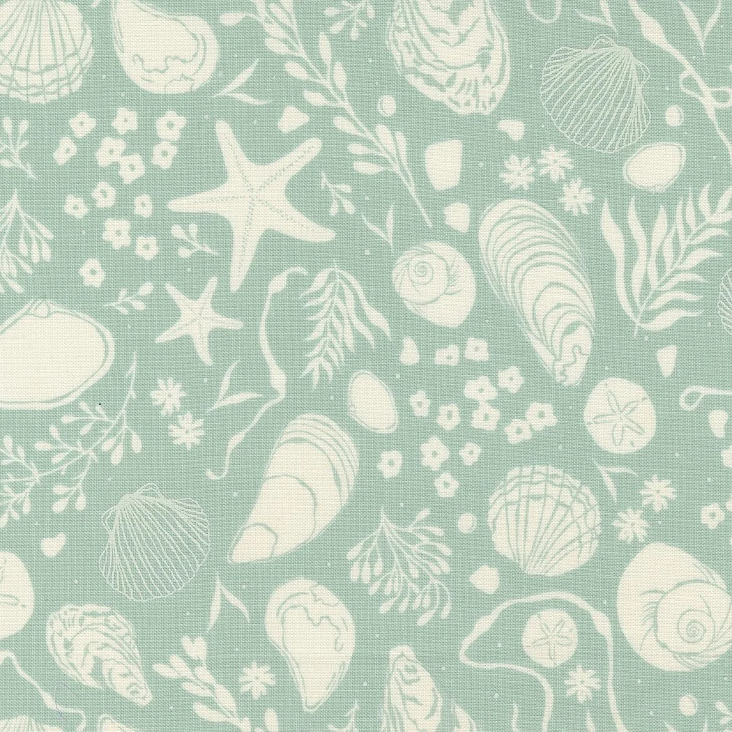 Light teal fabric with white illustrations of starfish, seashells, seaweed, and sandy beach elements.