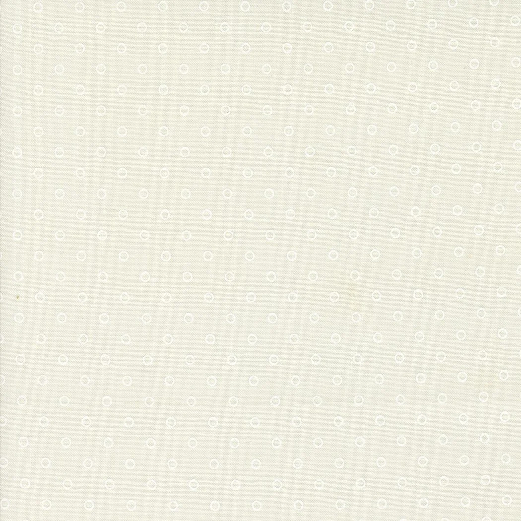 Light-colored, patterned background with small circular and square motifs.