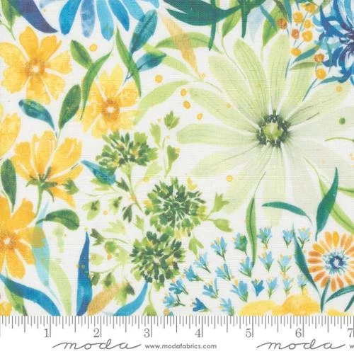 Colorful floral fabric pattern with yellow, green, blue, and orange flowers and leaves, featuring a ruler at the bottom for measurement.