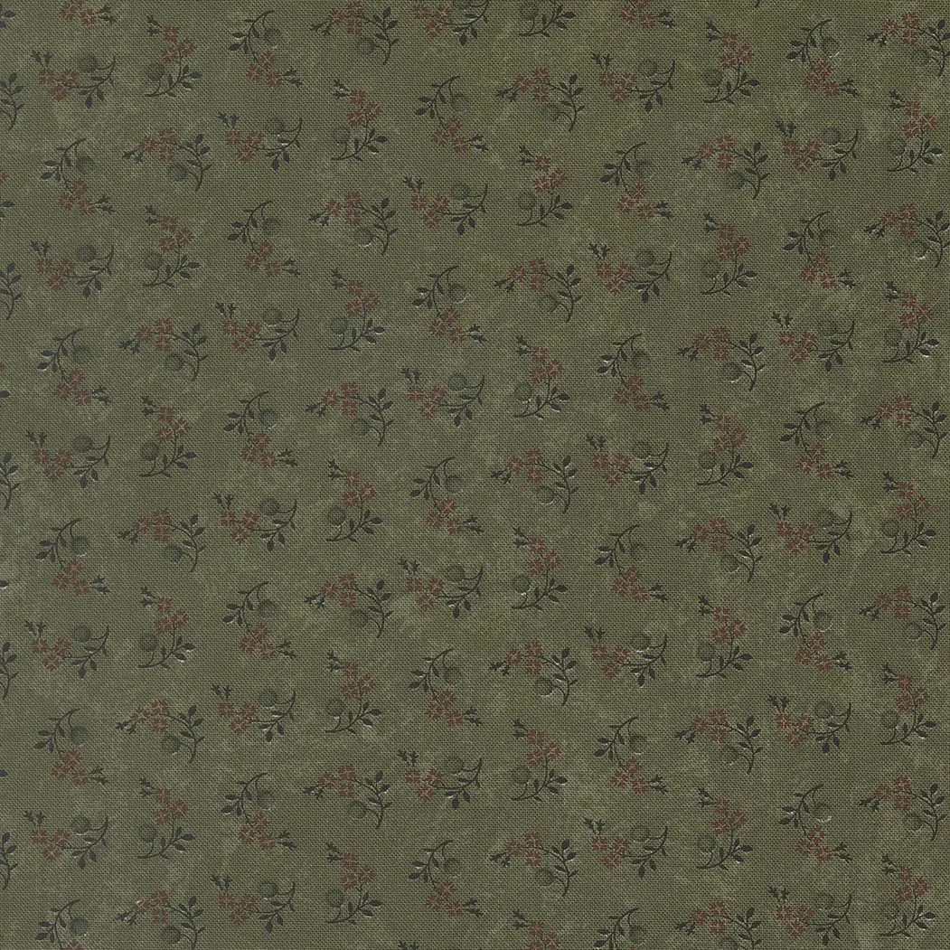 Green fabric with small floral pattern of red and dark green leaves and flowers.