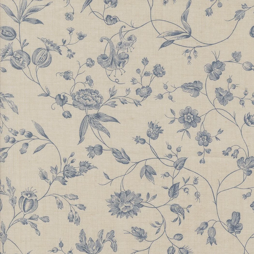 Cream-colored fabric with a blue floral pattern featuring various flowers, leaves, and vines.