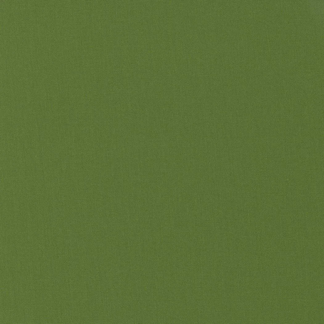 A plain green textured surface, possibly fabric or material.