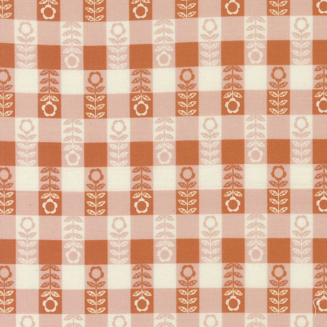 Red and white checkered tablecloth with geometric flower and leaf pattern.