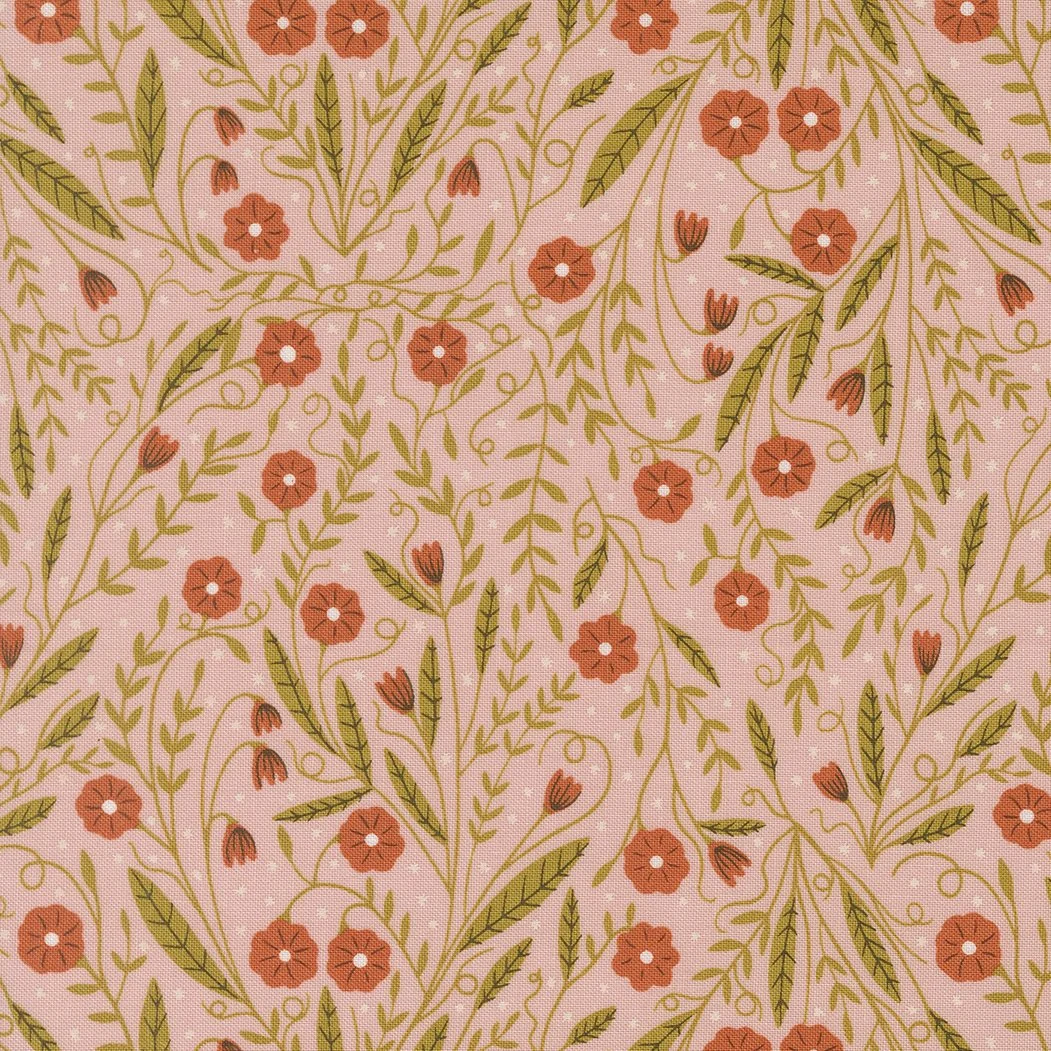 A fabric pattern with pink background and green leaves, small orange flowers, and tiny orange buds.