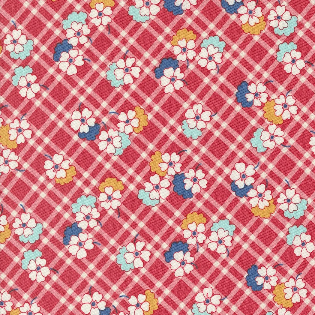 Pattern of small white and yellow flowers on a red and pink plaid background.
