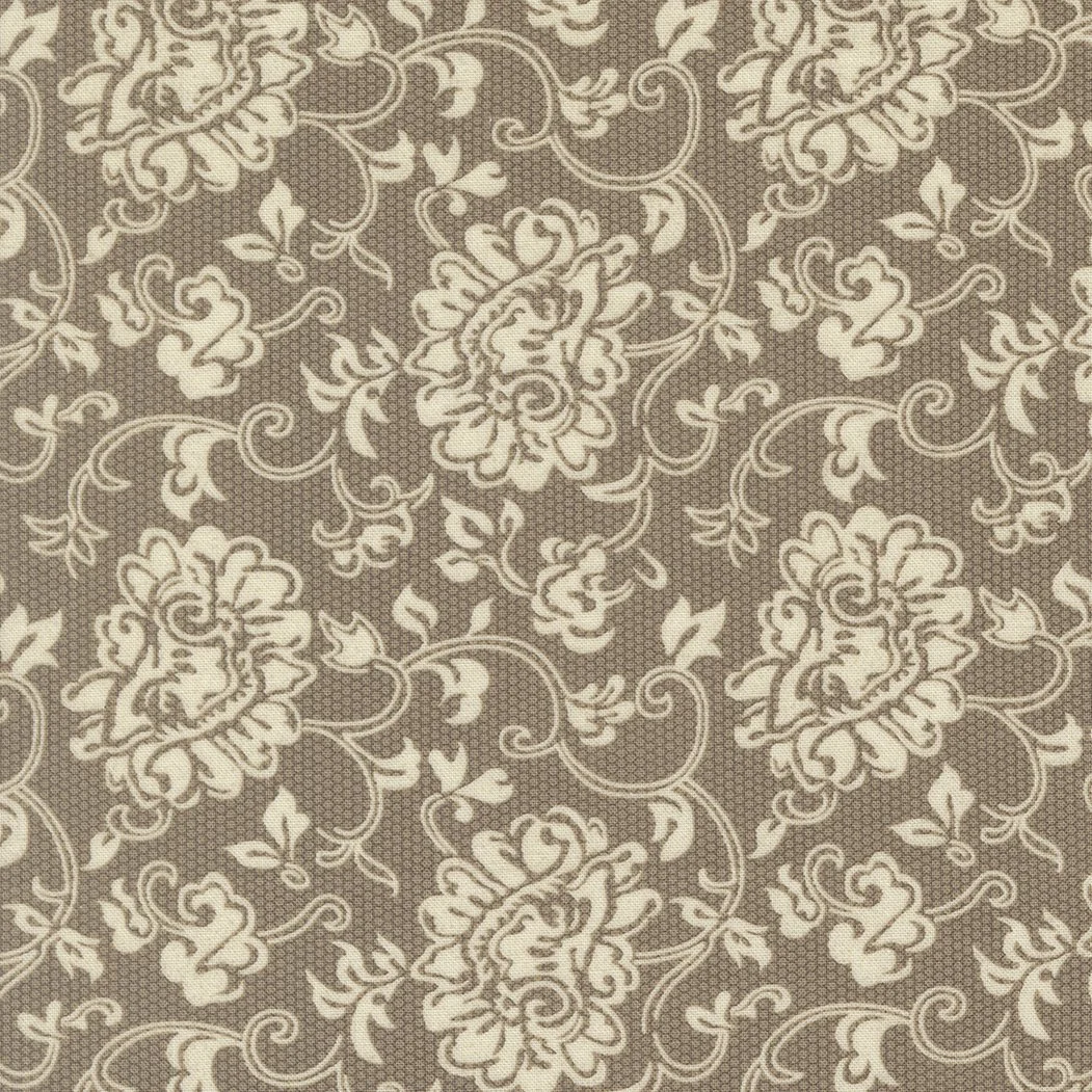 Brown fabric with a cream-colored floral and vine pattern.
