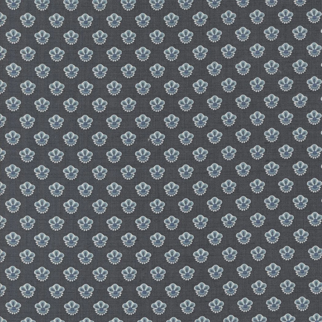 Close-up of fabric with a repeating pattern of light blue and white floral motifs on a dark background.