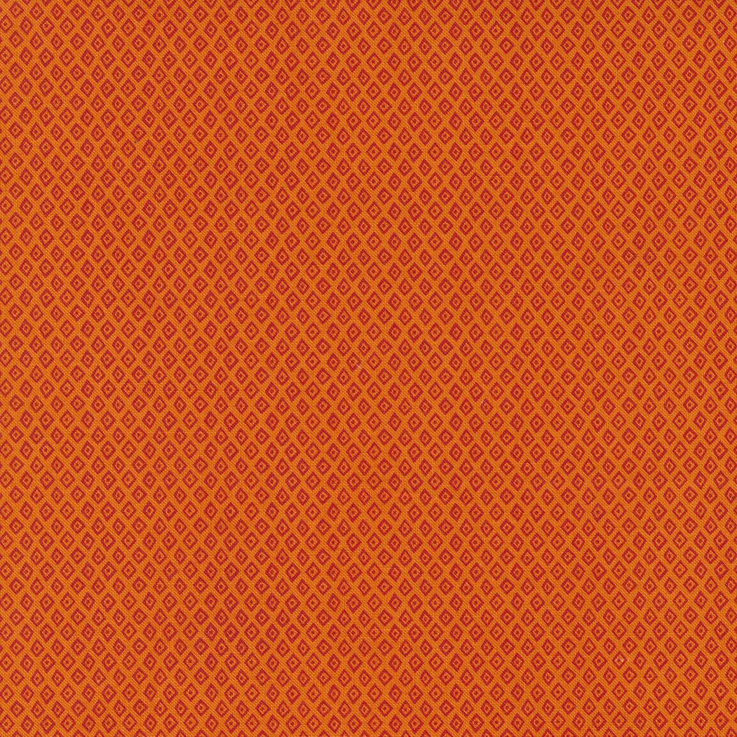 A patterned orange fabric with small yellow diamond shapes and red outlines.