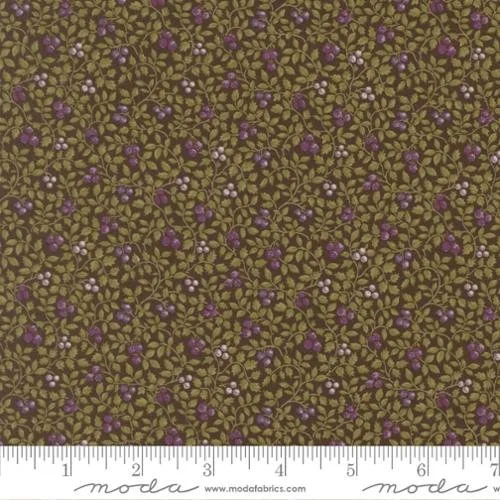 Close-up of fabric with a floral pattern of small purple, white, and pink flowers with green leaves on an olive background.